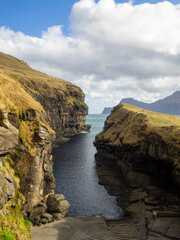 Gjógv rocky cleft harbour with Kalsoy in background