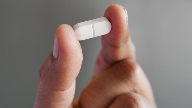 Close up of man hand holding pills with copy space 