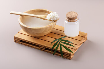 Homemade cosmetic rice water with ingredients and beauty kit on beige background, healthy beauty...