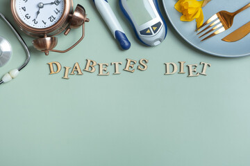 Diabetes Diet text. Stethoscope, glucometer and plate with copy space on colored background