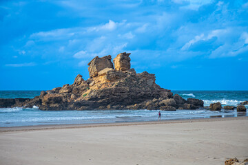 View of idyllic nature landscape with rocky cliff shore and waves crashing on. Rocks at surfer beach Praia do Castelejo near Sagres. West Atlantic coast of Algarve region, south of Portugal.