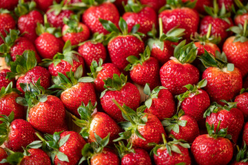Fresh strawberries with green leaves, strawberry background