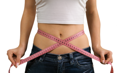 Female fitness model holding a tape measurer around her waist - weightloss concept