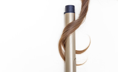 strand of woman blonde curly hair isolated and  straightener,curling iron,dryer rotating brush and other accessories.heat protection spray mockup free space advertising banner high quality photo.