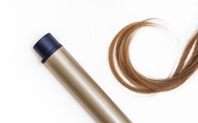 strand of woman blonde curly hair isolated and  straightener,curling iron,dryer rotating brush and other accessories.heat protection spray mockup free space advertising banner high quality photo.