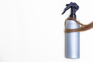 woman long curly hair strand threads isolated with cosmetic care product,mask spray oil serum,shampoo,balm.hair tangled in white comp,minimalism concept mock up free space for text,healthy natural