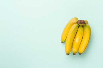 Fresh bananas on color background, top view