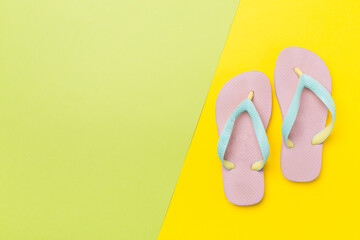 Bright flip flops on color background, top view