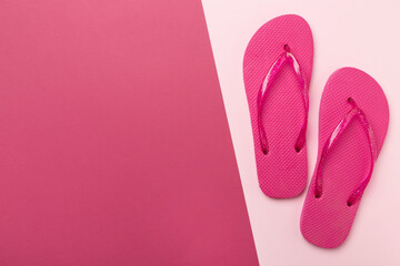 Bright flip flops on color background, top view