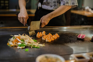 Tepanyaki - japanese grilled beef on pan. chef cooking at the hot table