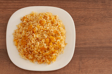 Toasted or stuck rice in the bottom of the pot.On a white plate.Fried