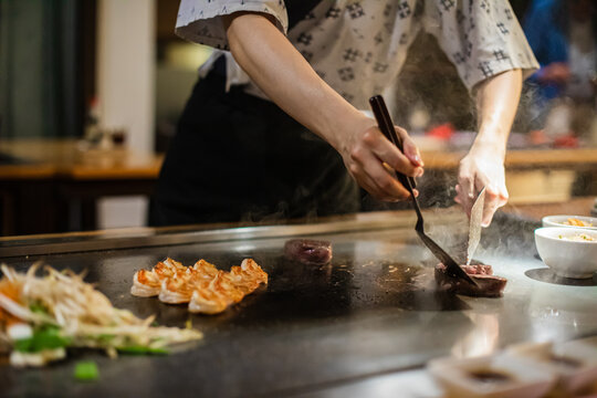 Tepanyaki - japanese grilled beef on pan. chef cooking at the hot table