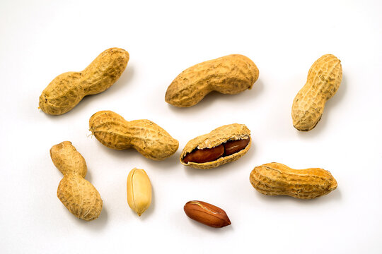 Dried Peanuts In Closeup On White