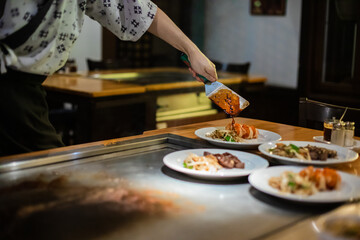 Tepanyaki - japanese grilled beef on pan. chef cooking at the hot table