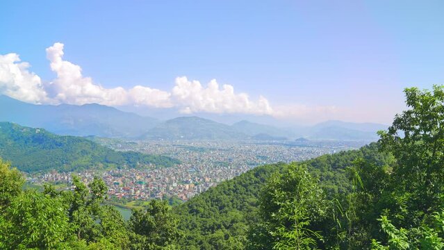 Aerial skyline view of Pokhara cityscape with the Annapurna mountain range and Phewa Lake, Nepal