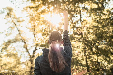 Strong confident woman with fist up! Winning and life goals concept.	