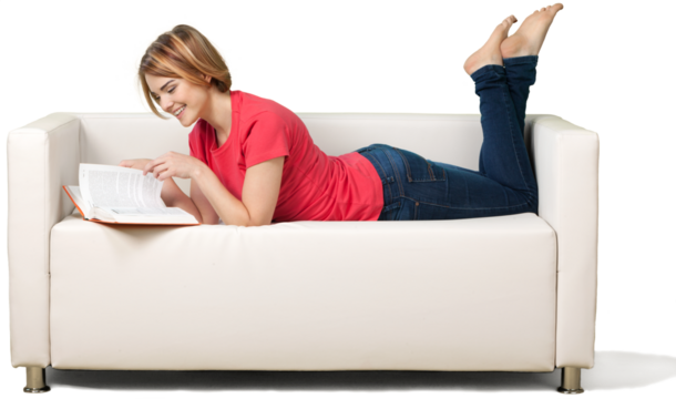 Girl laying on sofa and holding book isolated on white