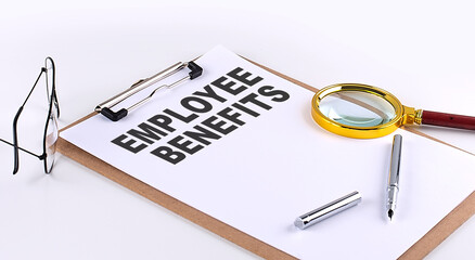 EMPLOYEE BENEFITS text on clipboard on white background, business concept