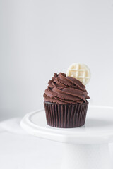 Chocolate cupcake with dark chocolate buttercream, double chocolate cupcakes with american buttercream, tall swirl frosting on a cupcake with a wafer