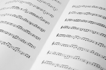 Sheet music book as background, closeup view