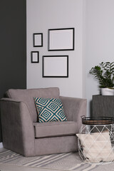 Empty frames hanging on white wall in stylish room