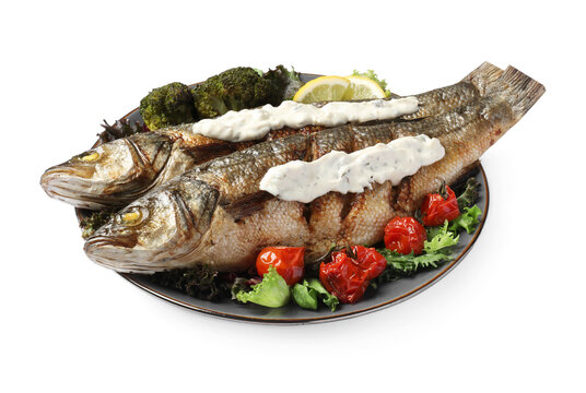 Plate with delicious sea bass fish and ingredients isolated on white