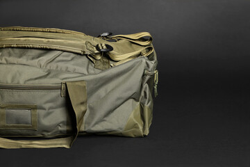Army bag on dark grey background, space for text. Military equipment