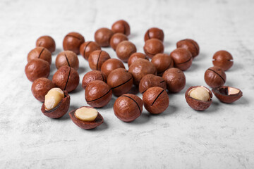 Delicious organic Macadamia nuts on white textured table
