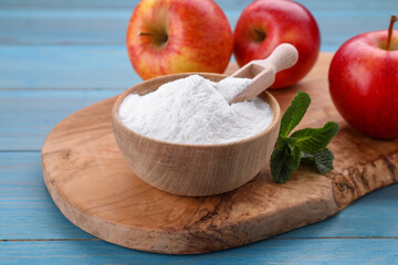 Sweet fructose powder, mint leaves and apples on light blue wooden table