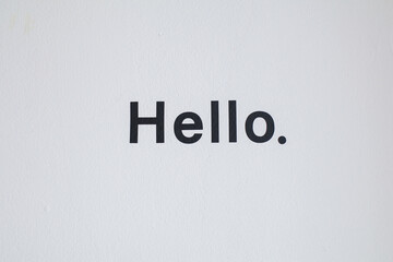 Hello word on white wall background. Communication concept, introduction. Lettering for banner, poster and sticker concept