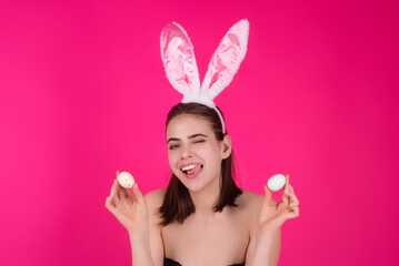 Obraz na płótnie Canvas Close up photo of pretty girl wear easter fluffy bunny ears hold easter eggs, isolated studio background. Eater portrait of female bunny.