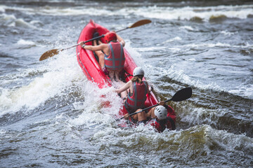 Raft boat during whitewater rafting extreme water sports on water rapids, kayaking and canoeing on...