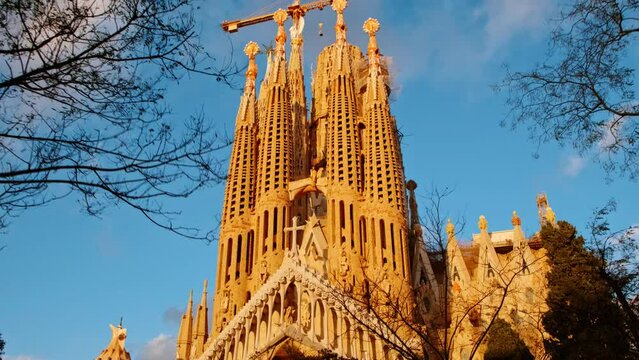 The Sagrada Familia basilica in Barcelona, Spain, the masterpiece of Antoni Gaudi, radiates in beautiful golden tones during sunset.