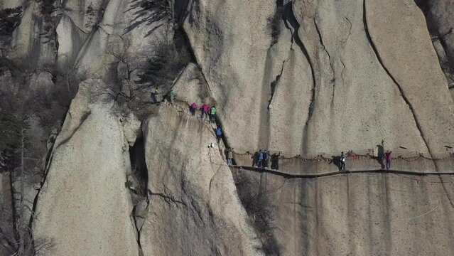 Aerial granite cliff view of sky plank tourist hike on Mount Huashan
