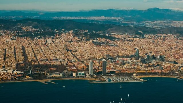 Aerial view of Barcelona, Catalonia, Spain, showcasing its stunning architecture, picturesque coastline, and several POIs including the Port and Montjuic