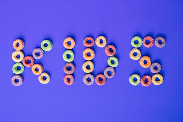 Cereal letters with the word kids. The cereal is colored circles