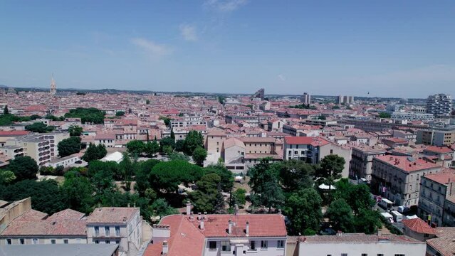 Aerial View of a Park in Montpellier on a Beautiful Day with Flying Birds and Landmarks
