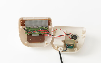 Open electric alarm, circuit boar and transformer isolate on white background.