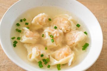 shrimp dumpling soup in white bowl