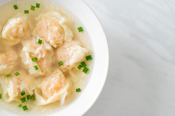 shrimp dumpling soup in white bowl