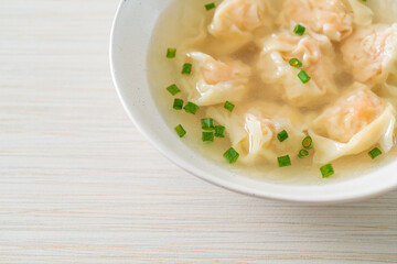 shrimp dumpling soup in white bowl