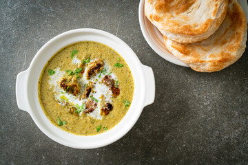 Afghani chicken in green masala curry or Hariyali tikka chicken hara masala with roti or naan bread