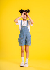 image full body of  asian little girl posing on a yellow background