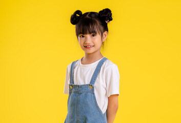 image  of  asian little girl posing on a yellow background