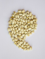 rest shape Pistachios isolated on white background, top view. 