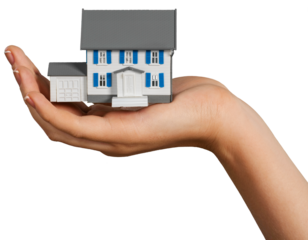 Hand holding house model isolated on white background