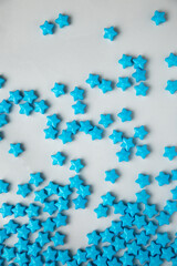 Blue star sugar sprinkles scattered on white