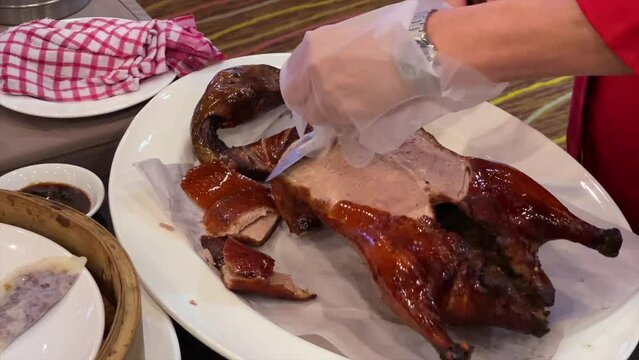 A closep-up of staff carving Peking Duck in a high-end Chinese restaurant in Kuala Lumpur, Malaysia