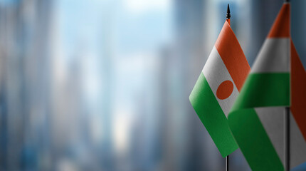 Small flags of the Niger on an abstract blurry background - obrazy, fototapety, plakaty