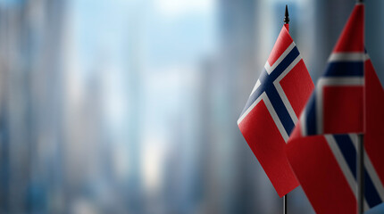 Fototapeta na wymiar Small flags of the Norway on an abstract blurry background